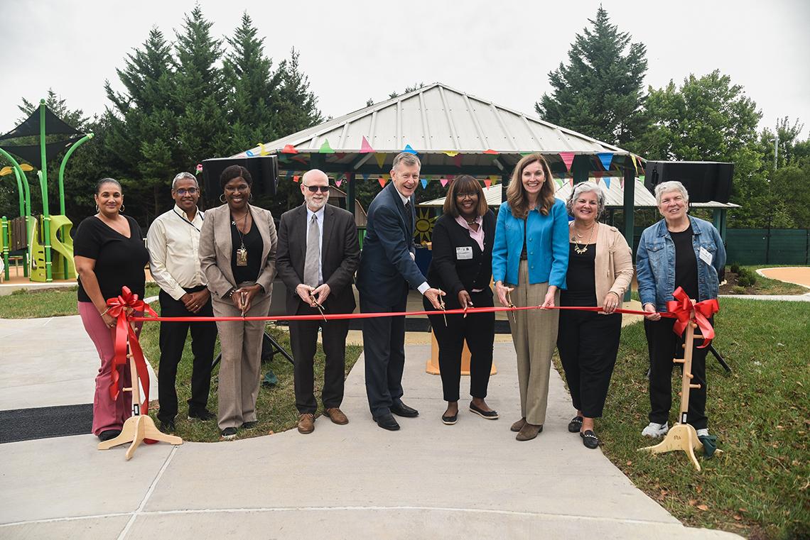 NIH leadership cuts ceremonial ribbon to officially reopen the playground
