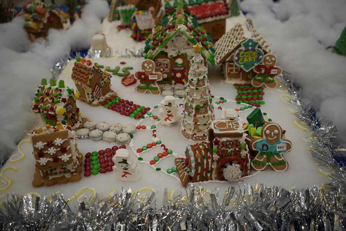 gingerbread men and snowmen hang out by different buildings, with M&Ms lining the paths.