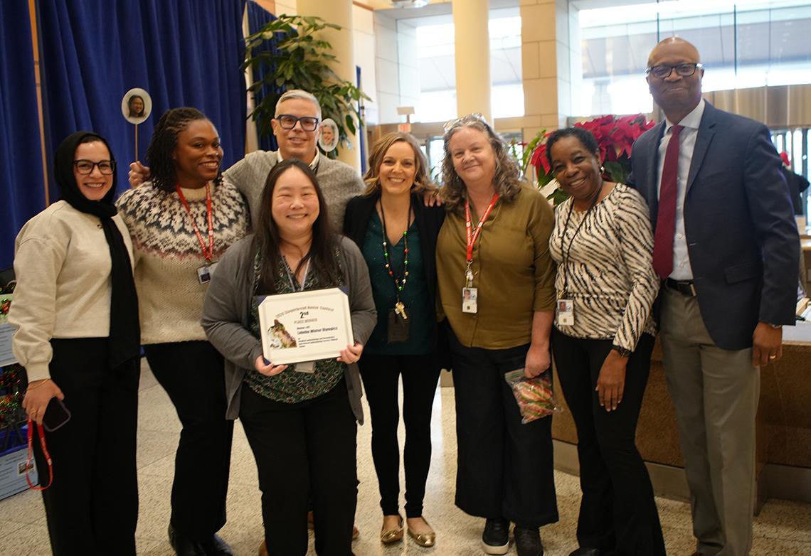 Second-place winners hold their certificate, pose with Aiyelawo