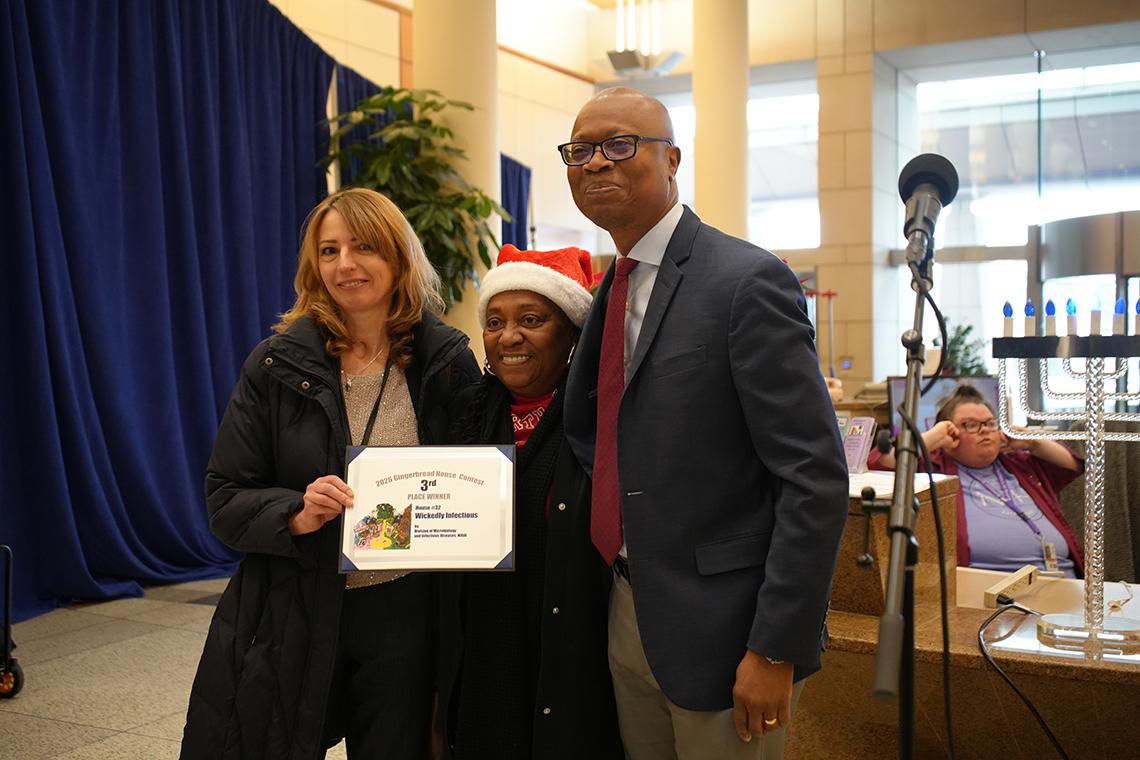 NIH team sculptors pose with Aiyelawo