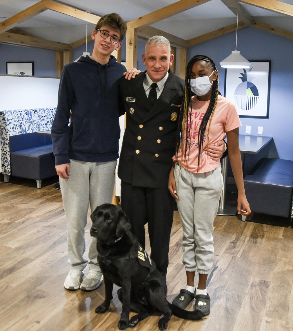 Christine and patients with a black dog