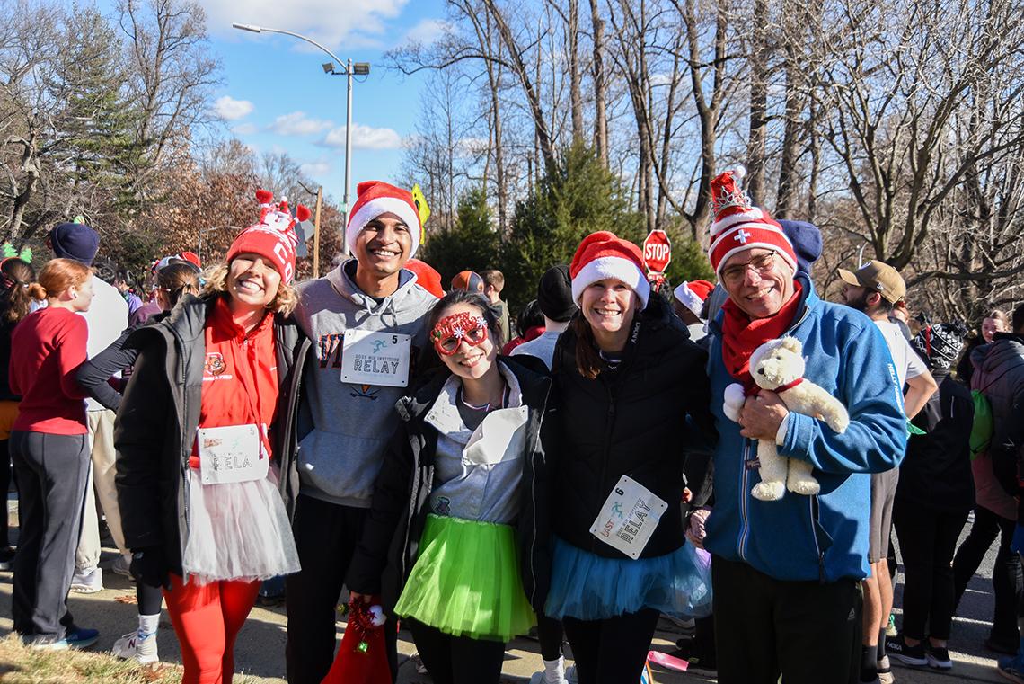 Relay runners pose for a group photo