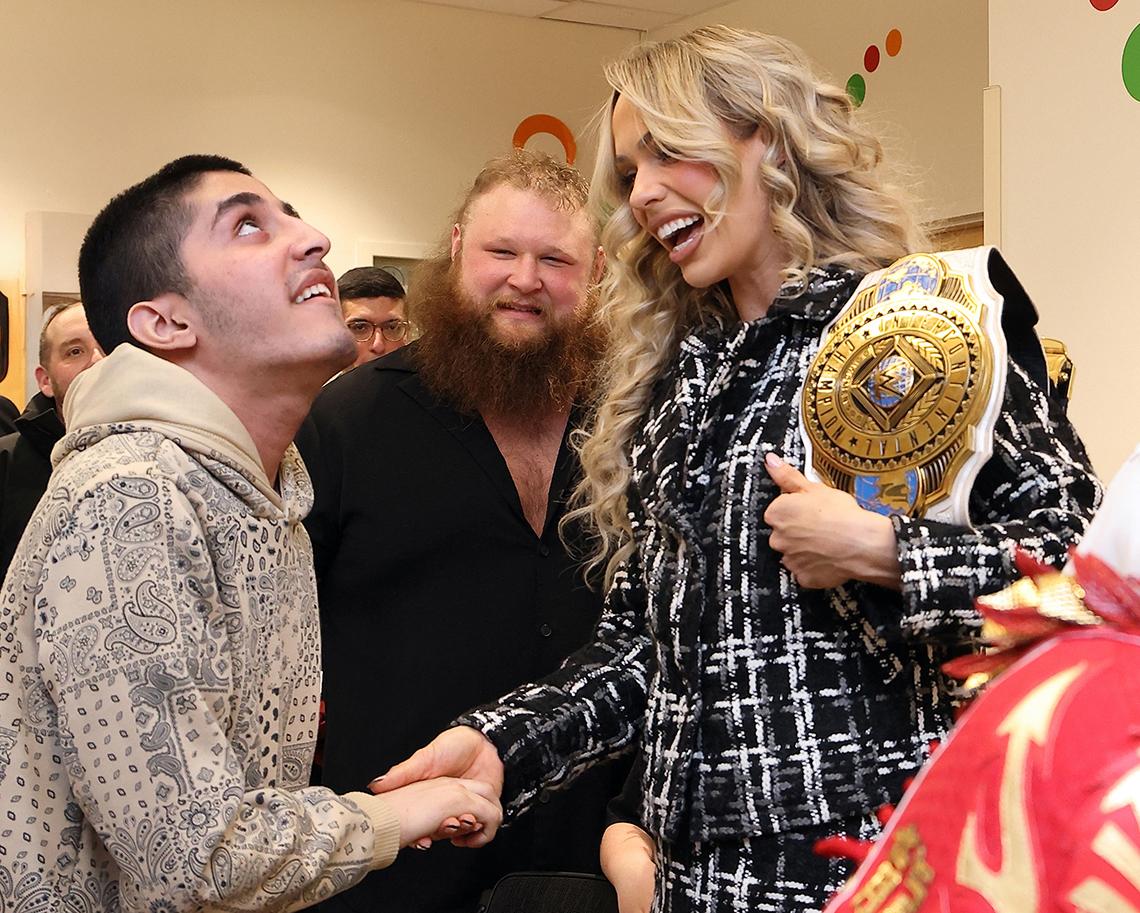 Dupri shakes child's hand as Otis looks on.