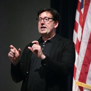 Scientist speaks at podium.
