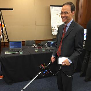 Ye points cane toward floor.