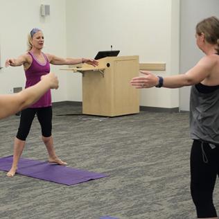 In workout clothes, Grant faces camera with arms outstretched.