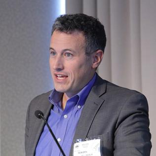 Dr. Roy Perlis speaks at podium in the Neuroscience Center