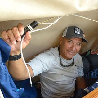 Archie Kalepa peers out from inside canoe