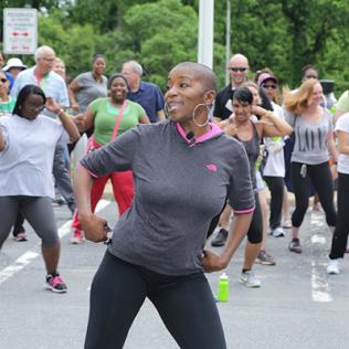 NIH'ers stretch together outside before the hike/run.