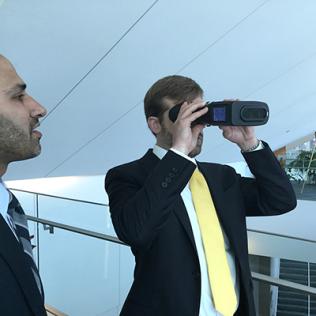 Attendee holds device up to his eyes.