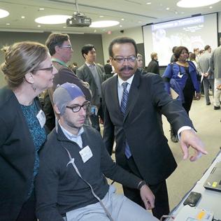 Dr. Pettigrew points to a display.