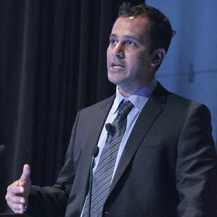 Doctor speaks at podium.