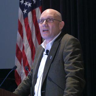 Rosenstein stands at podium