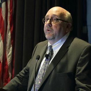 Dr. Steven Clinton speaks at podium