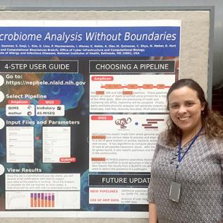 Quiñones stands in front of poster.