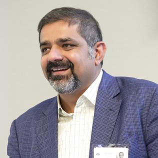 Dr. Karim Lakhani speaks at podium