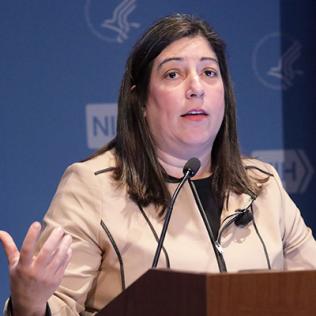 Houry at the podium at NIH