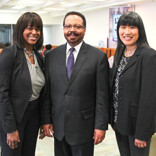 Pugh, Pettigrew and Peng pose together in the NIH Library.