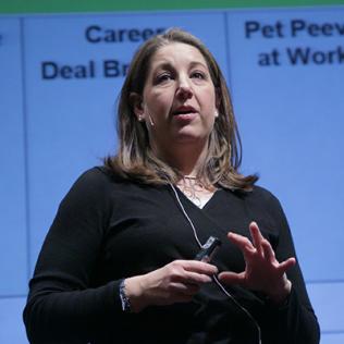 Harley stands speaking on stage