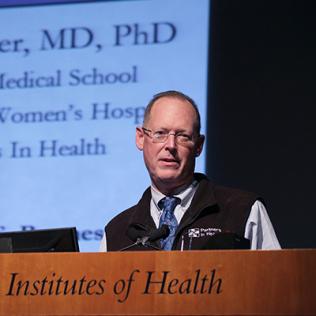 Dr. Farmer speaks at podium.