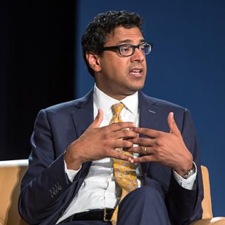 Dr. Atul Gawande interlaces fingers as he speaks
