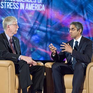 Dr. Collins and Dr. Murthy, seated on stage