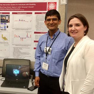 NICHD's Dr. Theresa Cruz visits a poster presented by Temple University’s Shivayogi Hiremath.