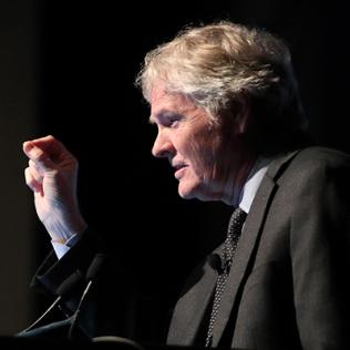 Dr. Young speaks at a podium