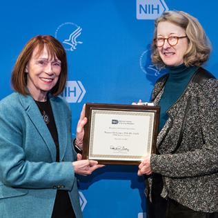 NINR director Dr. Grady presents plaque to Dr. Heitkemper