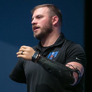 Mills shows off prosthetic arm