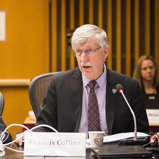 Dr. Collins delivers remarks as Dr. Tabak reviews his notes