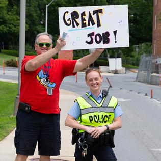 ORS’s Joe Cox and Cpl. Christine Fedorisko form cheering squad at hike.
