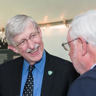 Dr. Roger Glass and Dr. Francis Collins reminisce with Dr. Warren Johnson.