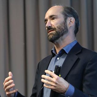 Dr. Michael Snyder speaking at the podium.