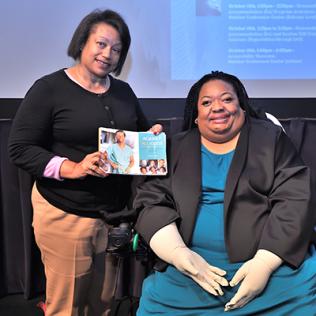 Crystal Emery (r) with EDI’s Kay Johnson Graham, holding Emery’s recent book.