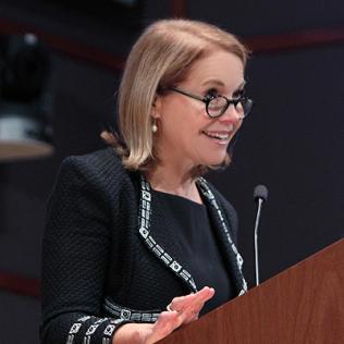 Katie Couric speaking at podium