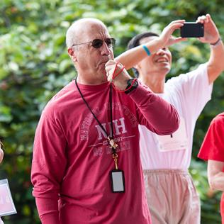 Dr. James Gilman blows a whistle to start the race.