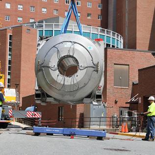 A crane lifts the magnet weighing 38,000 pounds.