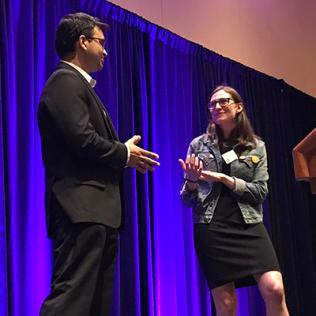 Dr. Sarthak Gupta does a practice interview with Sarah Kaplan onstage.