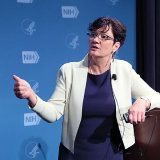 Dr. Mary Jo Larson speaking at the podium.