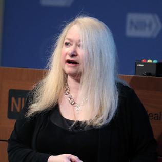 Dr. Berman stands in front of podium