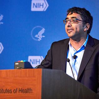 Shendure stands at podium.