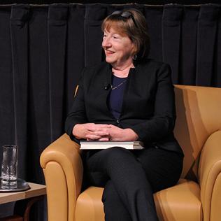 McNamara, seated on stage, talks about her new book.