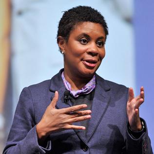 Dr. Alondra Nelson extends her hands during talk
