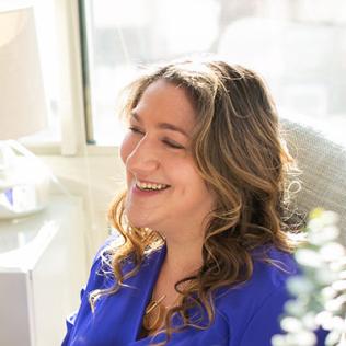 Spero smiles as she looks up from her laptop