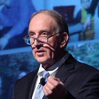 Dr. Philip May at podium