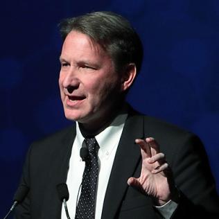 Dr. Sharpless speaks at podium