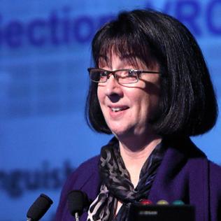 Dr. Nancy Sullivan talks from podium.