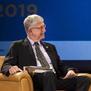 Dr. Collins on stage interviewing Thomson.