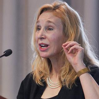 Dr. Sheena Josselyn speaks at podium in Neuroscience Center.